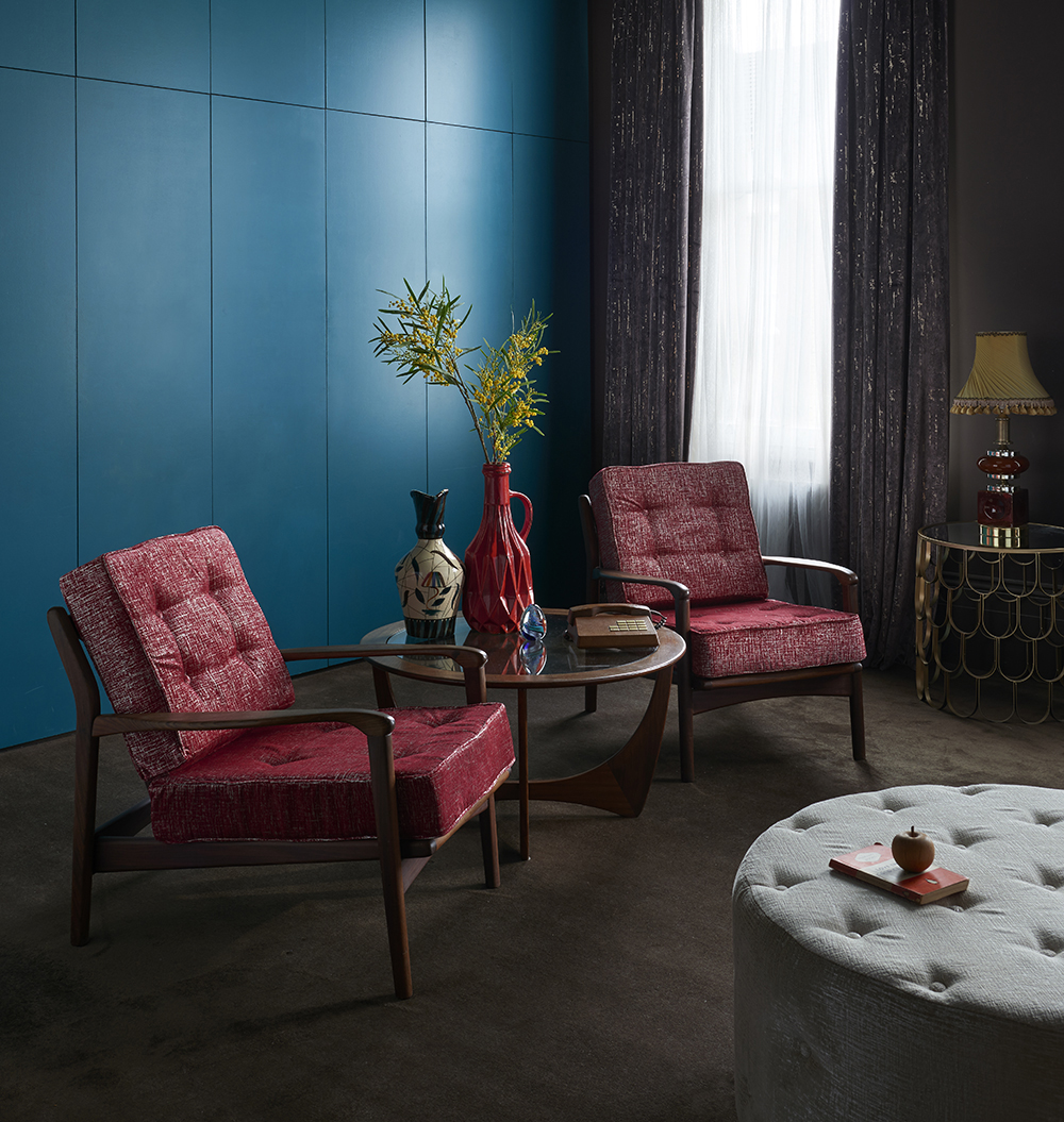 Bright maximalism with turquoise wall and red accessories