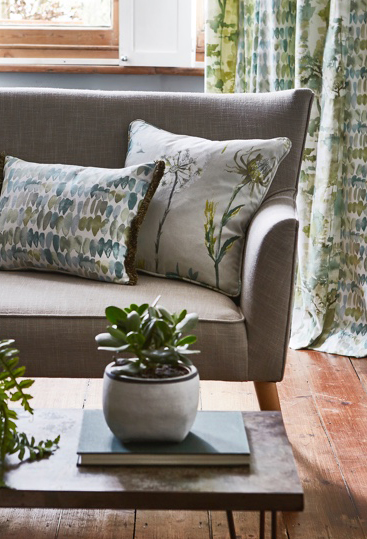 Grey sofa with sage cushions and sage curtains