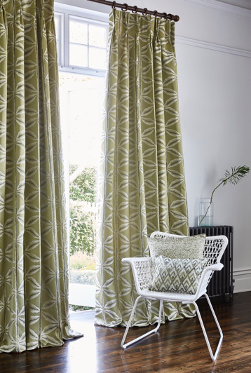Sage green curtains in white room