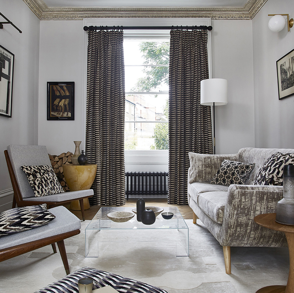 Black and white living room with trendy furniture and accessories.